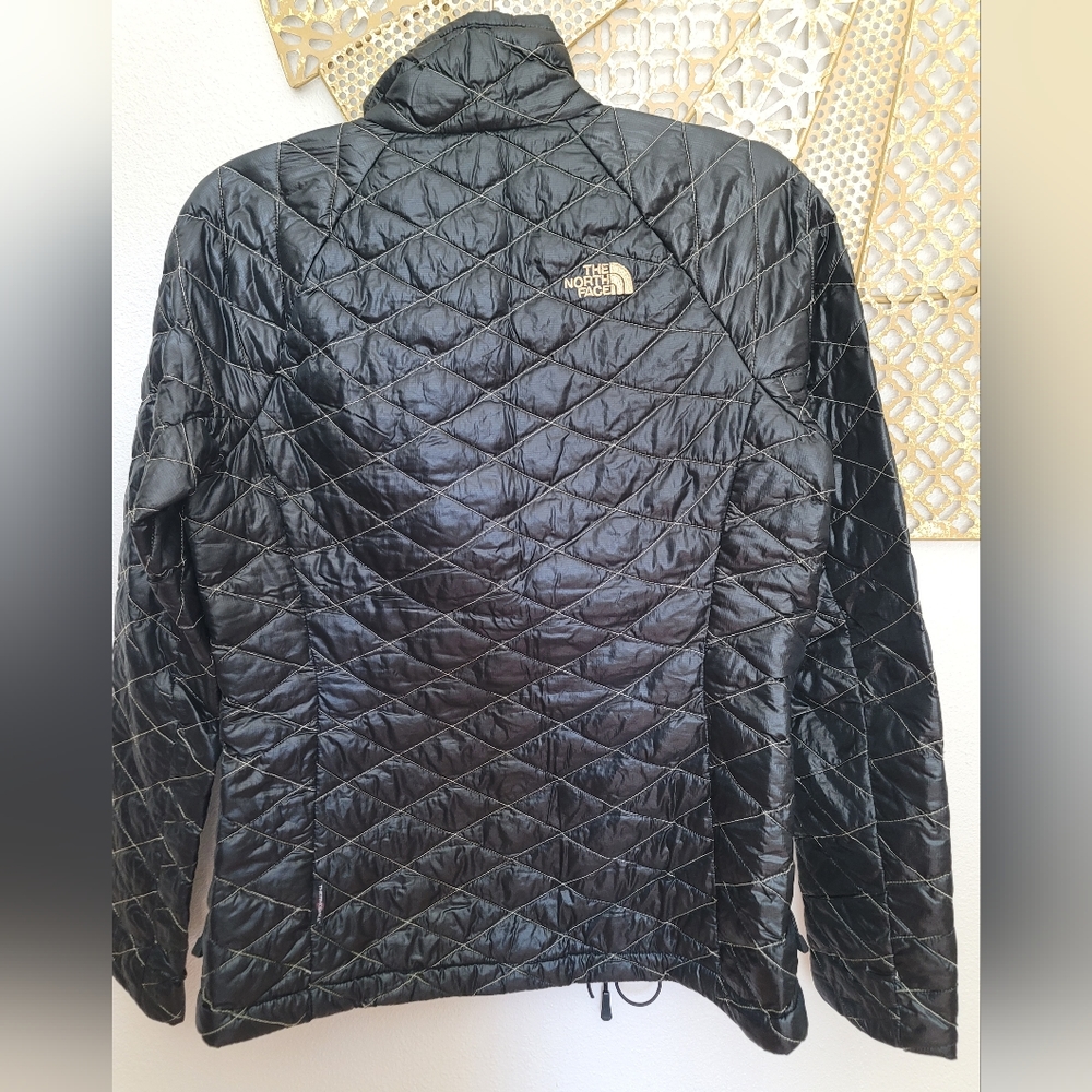 Packable black and gold The North Face Jacket
